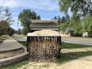 100 SP topdresser for sale from earth and turf spreading sand in a yard