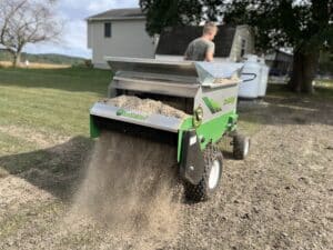 100sp topdressing being pulled in a backyard while spreading sand