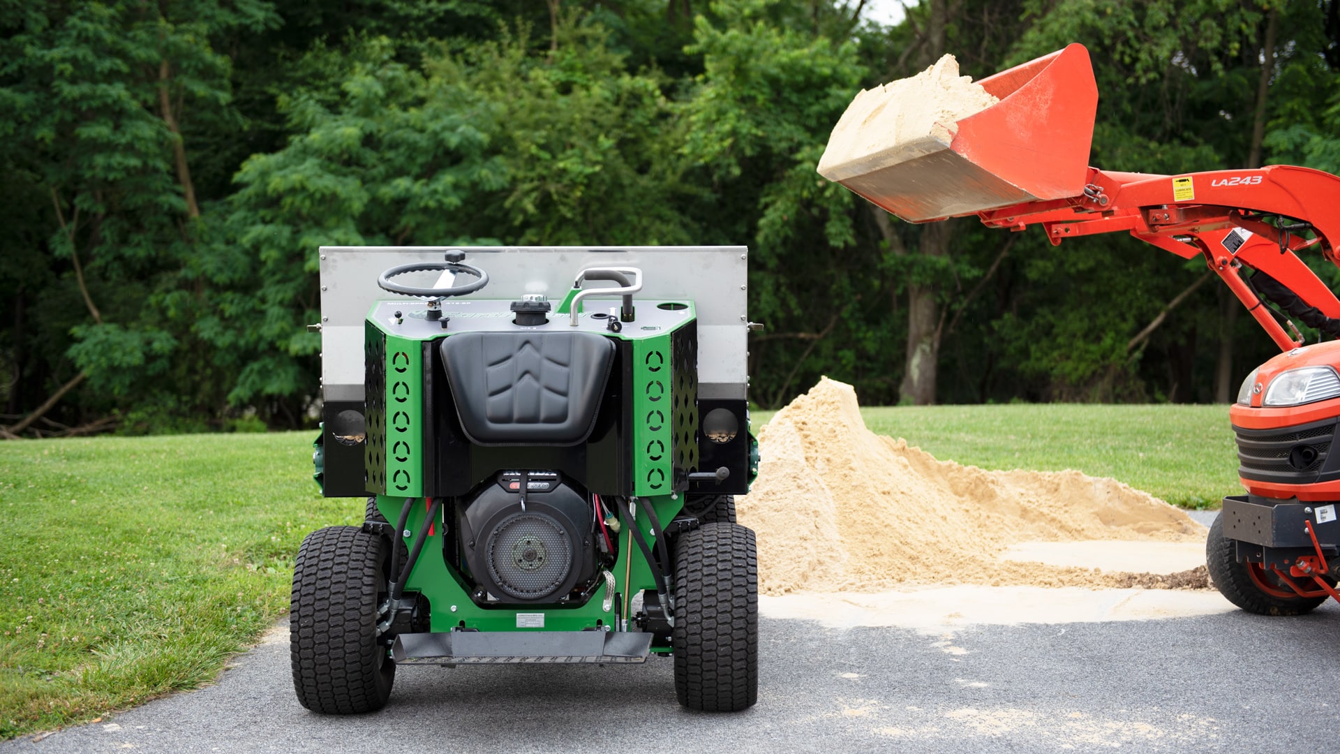 loading sand spreader with tractor for topdressing